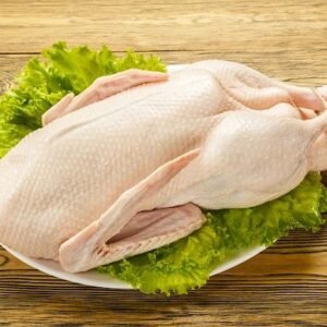 The duck is raw, ready to cook. Gutted carcass of a bird. Wooden table. Recipe preparations. Dietary food. Health food. Farm product.